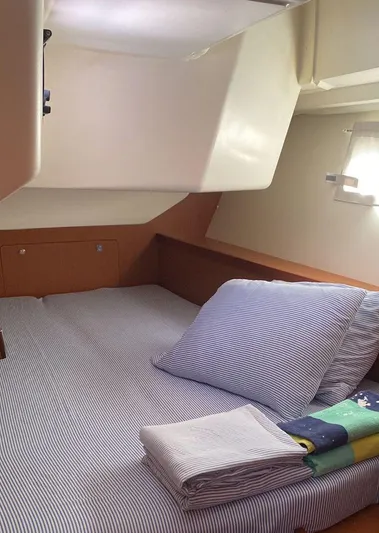 Sv Tonic III Yacht Photos Pics Cozy cabin interior of 2012 Beneteau Oceanis 41.1 sailboat with striped bedding.
