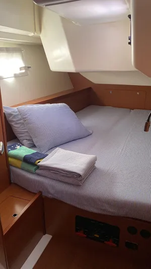 Sv Tonic III Yacht Photos Pics Cozy cabin interior of 2012 Beneteau Oceanis 41.1 yacht with striped bedding.