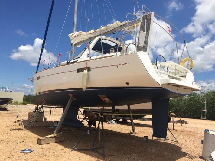 Sv Tonic III Yacht Photos Pics Beneteau Oceanis 41.1 sailboat on land, 2012 model, undergoing maintenance under a clear blue sky.