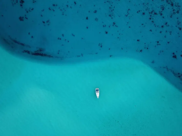 Sv Tonic III Yacht Photos Pics Aerial view of 2012 Beneteau Oceanis 41.1 sailboat on turquoise water.