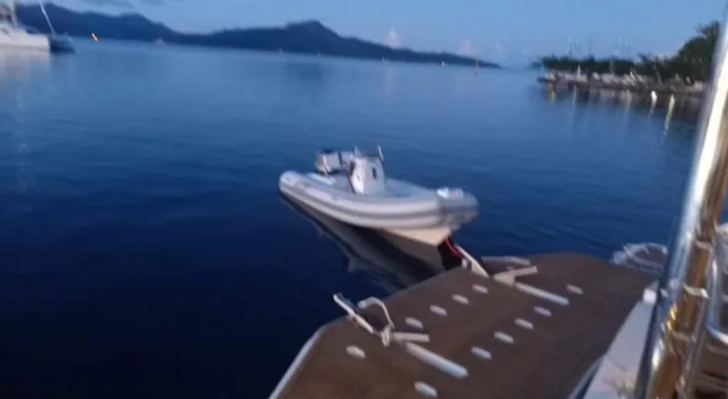 Oe Hani Yacht Photos Pics A Leopard 58 yacht with a small boat on calm waters at dusk, 2018.