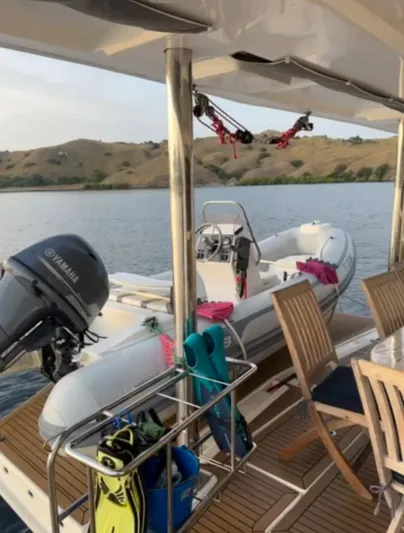 Oe Hani Yacht Photos Pics A 2018 Leopard 58 yacht with a Yamaha motorboat on deck, overlooking serene waters.