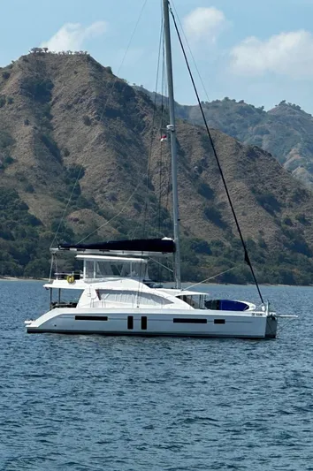 Oe Hani Yacht Photos Pics Luxury Leopard 58 catamaran sailing near scenic mountainous coastline, 2018 model.