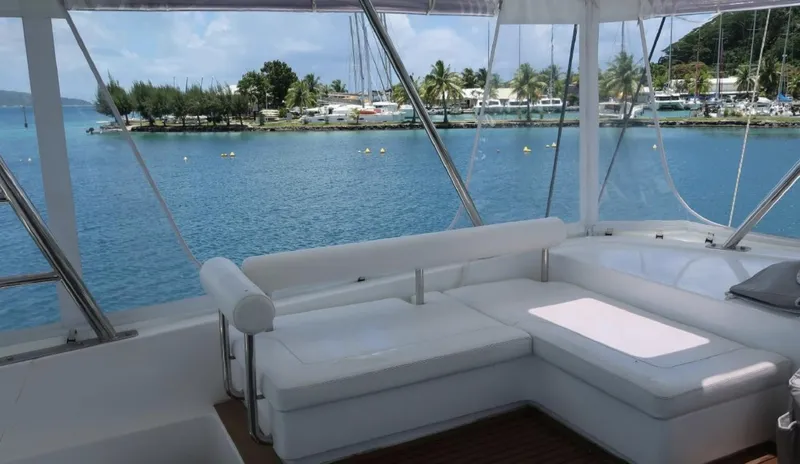 Oe Hani Yacht Photos Pics Luxurious Leopard 58 yacht interior with ocean view, featuring white seating and clear skies.