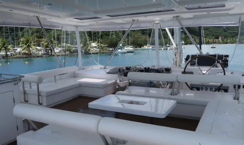 Oe Hani Yacht Photos Pics Luxurious 2018 Leopard 58 yacht interior with white seating, table, and scenic marina view.