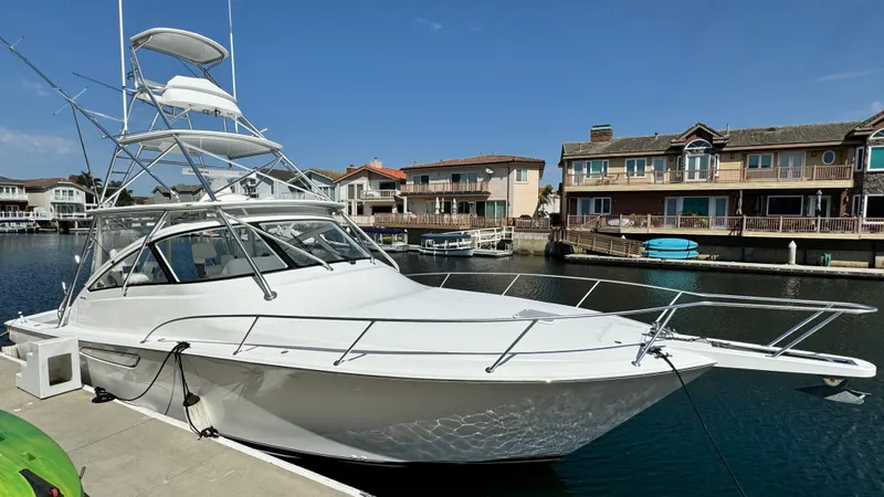  Yacht Photos Pics 2012 Viking 42 Open yacht docked in front of houses.