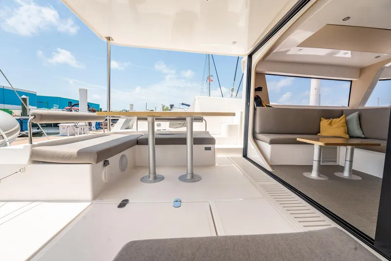 Big Bird Yacht Photos Pics Spacious deck and seating area on 2021 NEEL 47 trimaran yacht.