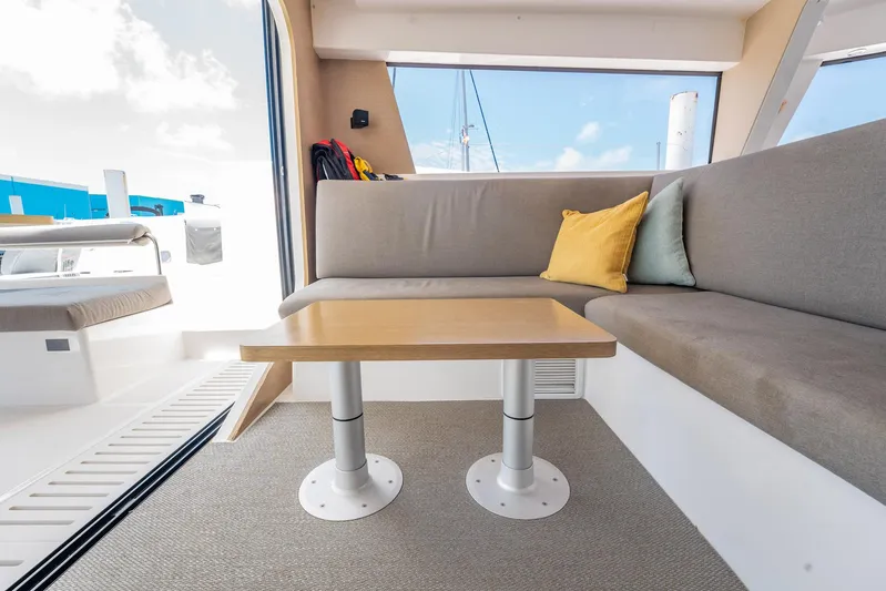 Big Bird Yacht Photos Pics Interior of 2021 NEEL 47 trimaran with cozy seating and table.