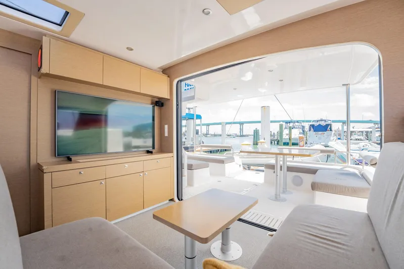 Big Bird Yacht Photos Pics Interior of 2021 NEEL 47 yacht with modern seating and outdoor view.
