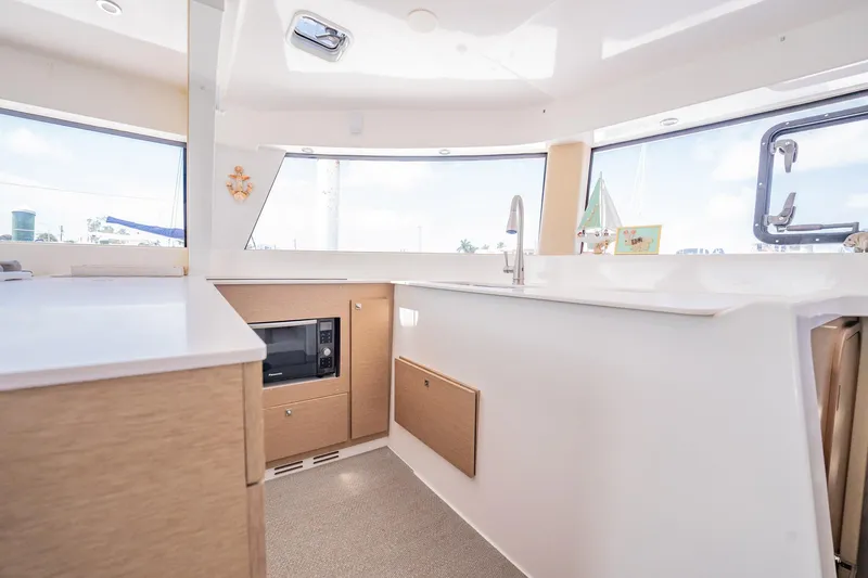 Big Bird Yacht Photos Pics Modern NEEL 47 yacht interior with sleek kitchen design, featuring a microwave and ample natural light.