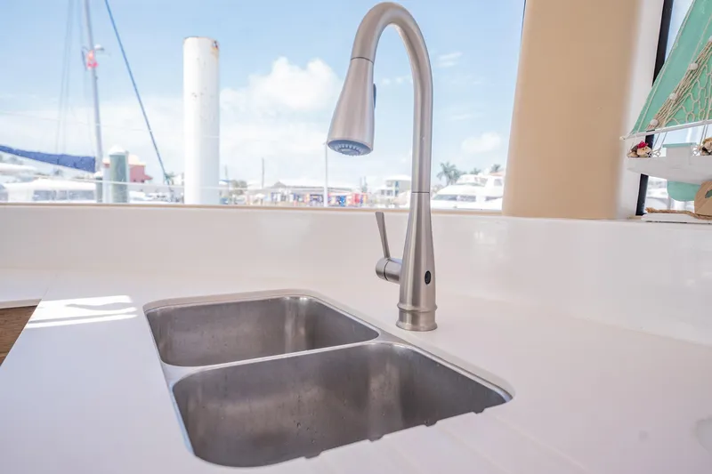 Big Bird Yacht Photos Pics Modern kitchen sink with dual basins and sleek faucet on NEEL 47 trimaran, 2021 model.