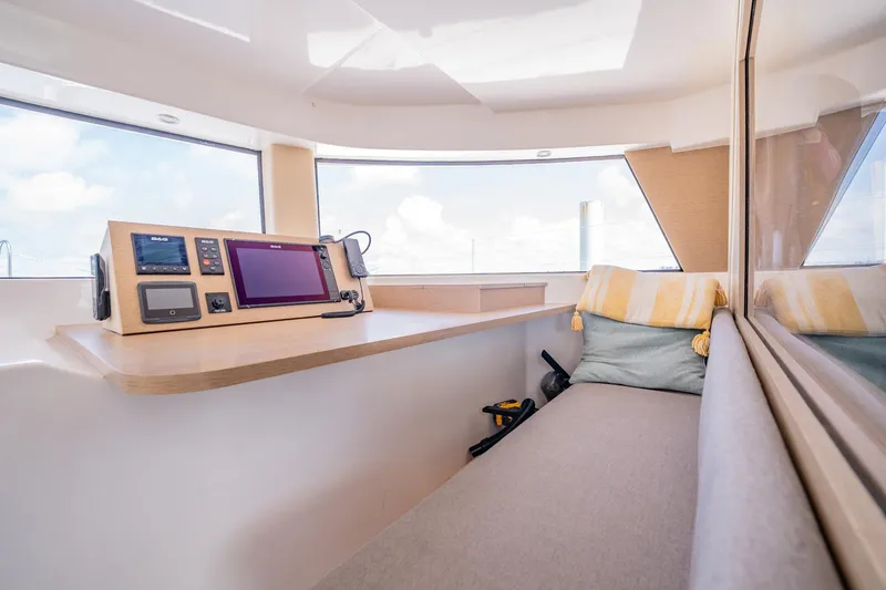 Big Bird Yacht Photos Pics Interior of 2021 NEEL 47 trimaran with navigation equipment and cozy seating area.