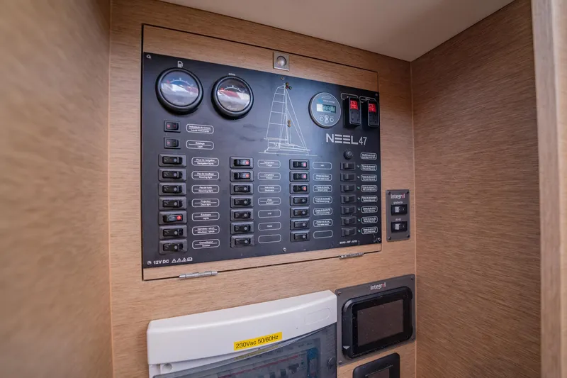 Big Bird Yacht Photos Pics Electrical control panel of a 2021 NEEL 47 trimaran, featuring gauges and switches.
