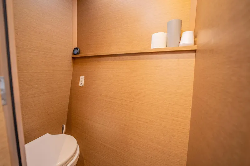 Big Bird Yacht Photos Pics Compact wooden bathroom interior on NEEL 47, 2021 model, with toilet and shelf.