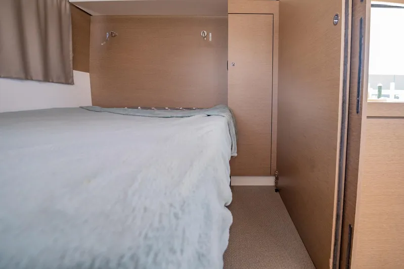Big Bird Yacht Photos Pics Interior cabin of 2021 NEEL 47, featuring a cozy bed and wooden paneling.