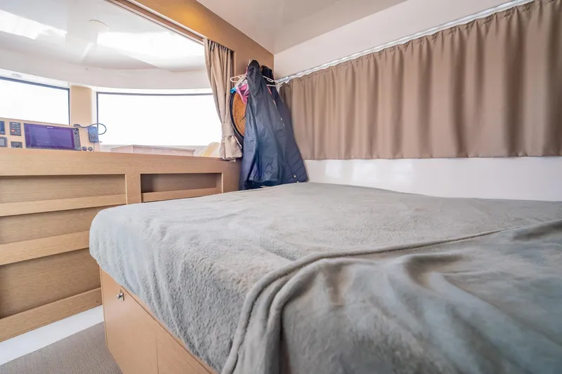 Big Bird Yacht Photos Pics Interior cabin of 2021 NEEL 47 with bed, curtains, and storage.