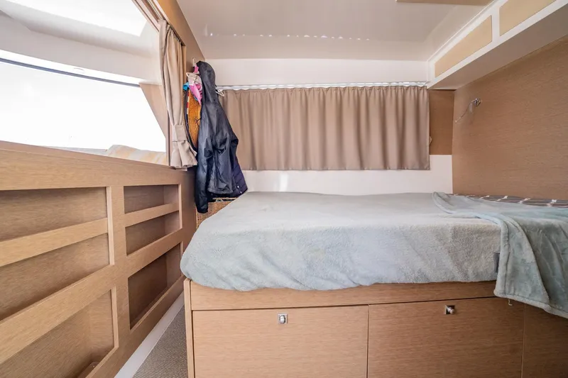 Big Bird Yacht Photos Pics Cozy cabin interior of 2021 NEEL 47 with bed, storage, and window.