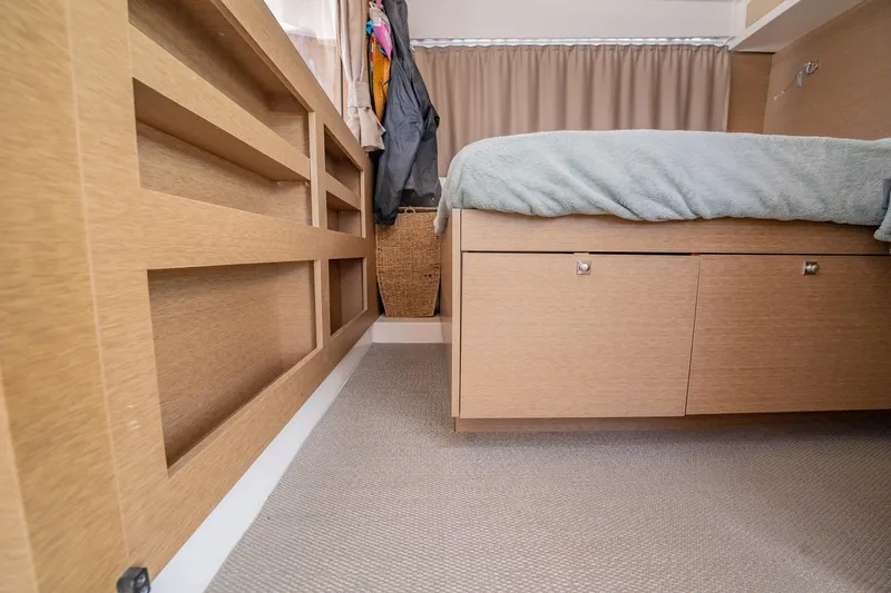 Big Bird Yacht Photos Pics Interior of NEEL 47 (2021) showing bedroom with wooden storage and bed.