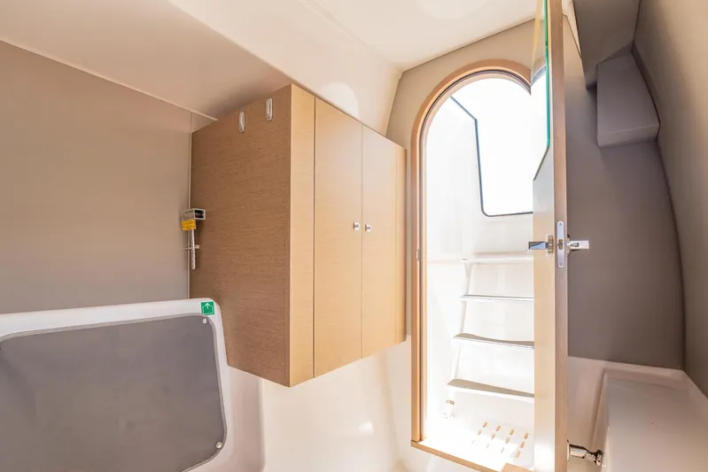 Big Bird Yacht Photos Pics Interior of 2021 NEEL 47 yacht, featuring wooden cabinets and a sunlit doorway.