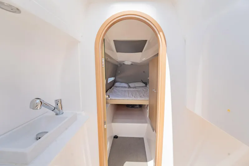 Big Bird Yacht Photos Pics Interior cabin of 2021 NEEL 47 with bed and sink, featuring modern design.