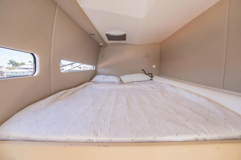 Big Bird Yacht Photos Pics Cozy cabin interior of 2021 NEEL 47 with a comfortable bed and side windows.