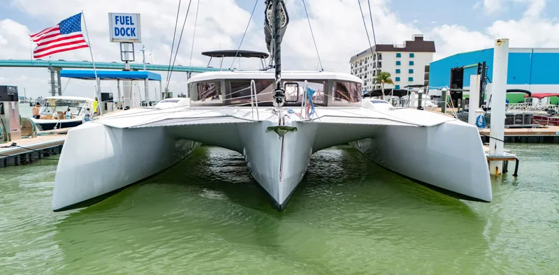 Big Bird Yacht Photos Pics 2021 NEEL 47 trimaran docked at marina with American flag and fuel dock sign.