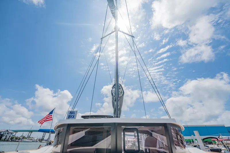 Big Bird Yacht Photos Pics NEEL 47 trimaran sailing under sunny skies with American flag, 2021 model.