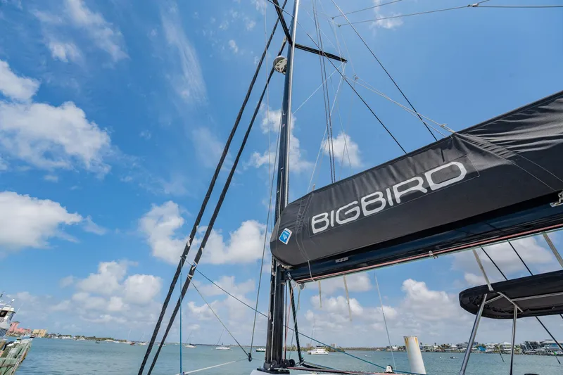 Big Bird Yacht Photos Pics Sailboat mast and sail labeled "Bigbird" on NEEL 47, 2021 model, under blue sky.