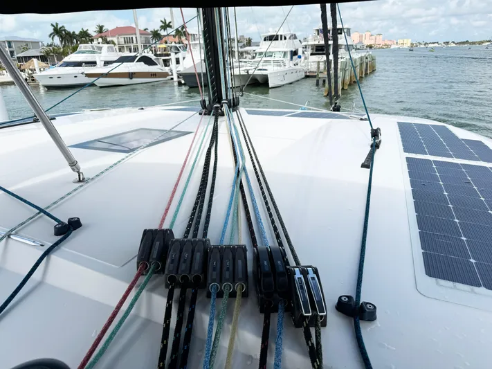 Big Bird Yacht Photos Pics Deck view of 2021 NEEL 47 trimaran with ropes and solar panels in a marina.