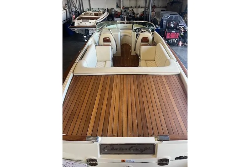  Yacht Photos Pics 2024 Chris-Craft Launch 27 boat with elegant wooden deck and luxurious seating.