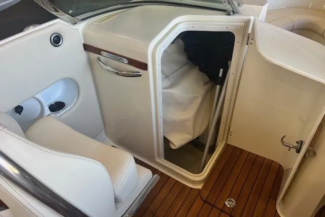  Yacht Photos Pics 2024 Chris-Craft Launch 27 interior with open storage compartment and elegant wood flooring.