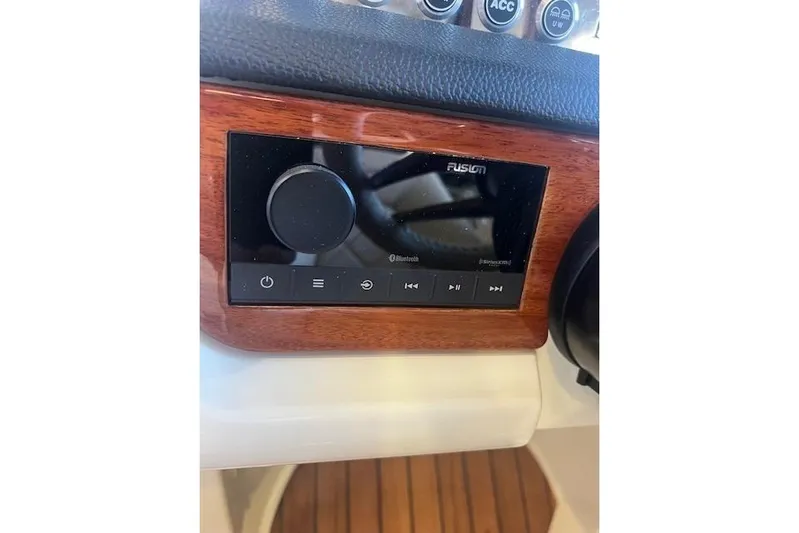  Yacht Photos Pics 2024 Chris-Craft Launch 27 dashboard with Fusion audio system and Bluetooth connectivity.