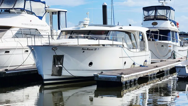 Sea-solar Sue & Lectric Lee Yacht Photos Pics 2022 Greenline 40 yacht docked at marina, surrounded by other boats.