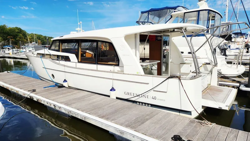 Sea-solar Sue & Lectric Lee Yacht Photos Pics 2022 Greenline 40 yacht docked at marina under clear blue sky.