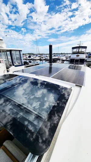 Sea-solar Sue & Lectric Lee Yacht Photos Pics Greenline 40 yacht with solar panels, docked at marina under a partly cloudy sky, 2022 model.