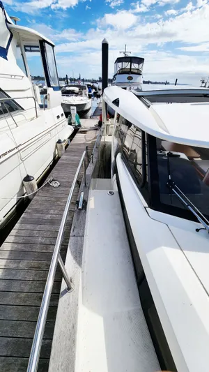 Sea-solar Sue & Lectric Lee Yacht Photos Pics 2022 Greenline 40 yacht docked at marina under blue sky.