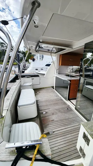 Sea-solar Sue & Lectric Lee Yacht Photos Pics 2022 Greenline 40 yacht deck with seating and kitchenette, docked at marina.