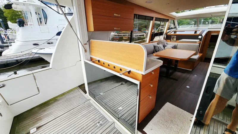 Sea-solar Sue & Lectric Lee Yacht Photos Pics Interior of 2022 Greenline 40 yacht with modern wood finish and spacious seating area.