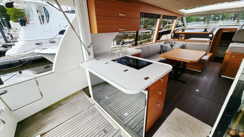 Sea-solar Sue & Lectric Lee Yacht Photos Pics Interior of 2022 Greenline 40 yacht with modern kitchen and seating area.