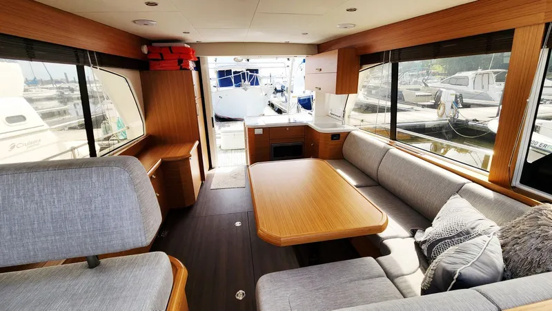 Sea-solar Sue & Lectric Lee Yacht Photos Pics Interior of 2022 Greenline 40 yacht with modern seating and large windows.