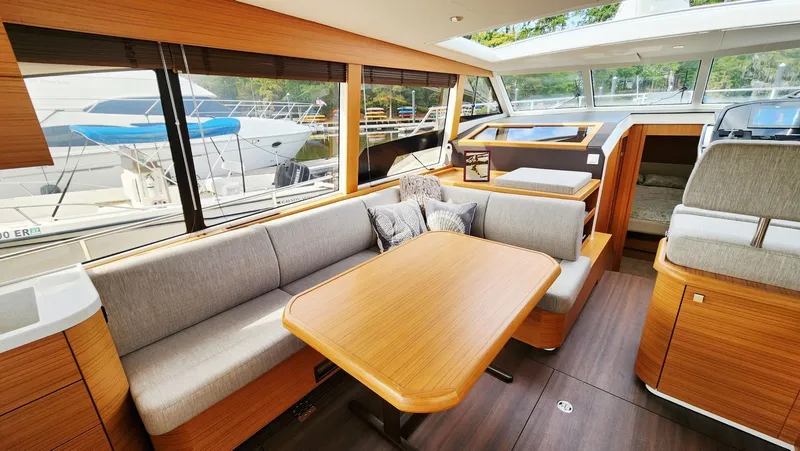 Sea-solar Sue & Lectric Lee Yacht Photos Pics Luxurious interior of 2022 Greenline 40 yacht with modern seating and wooden finishes.