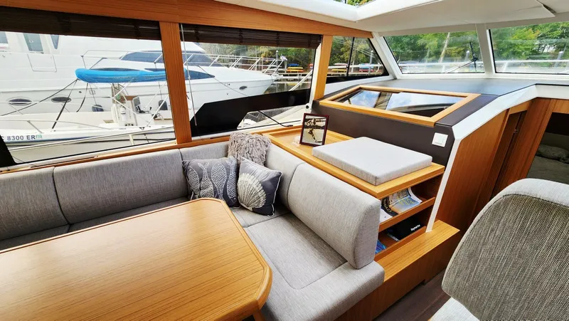Sea-solar Sue & Lectric Lee Yacht Photos Pics Interior of 2022 Greenline 40 yacht with modern seating and wooden accents.