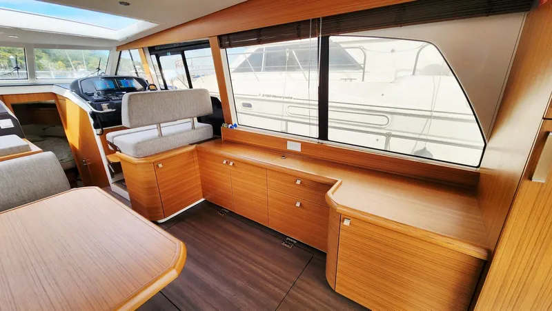 Sea-solar Sue & Lectric Lee Yacht Photos Pics Interior of 2022 Greenline 40 yacht with modern wood finish and large windows.