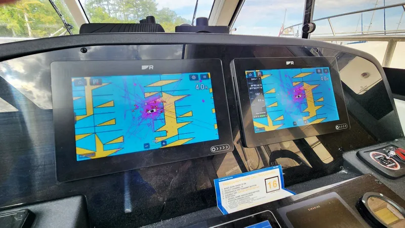 Sea-solar Sue & Lectric Lee Yacht Photos Pics Cockpit navigation screens on a 2022 Greenline 40 yacht displaying digital maps.