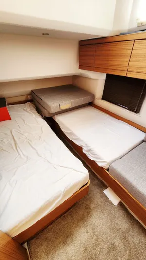 Sea-solar Sue & Lectric Lee Yacht Photos Pics 2022 Greenline 40 yacht interior with twin beds and wooden cabinetry.