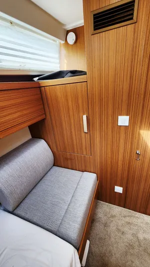 Sea-solar Sue & Lectric Lee Yacht Photos Pics Interior of 2022 Greenline 40 yacht with wooden paneling and gray seating.