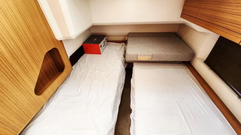 Sea-solar Sue & Lectric Lee Yacht Photos Pics Interior cabin of 2022 Greenline 40 yacht with twin beds and wooden accents.