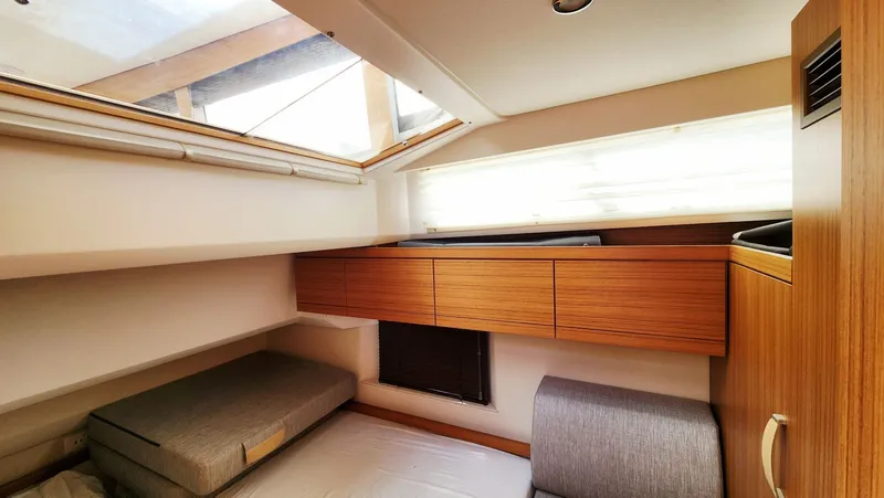 Sea-solar Sue & Lectric Lee Yacht Photos Pics Interior of 2022 Greenline 40 yacht cabin with wooden cabinetry and skylight.