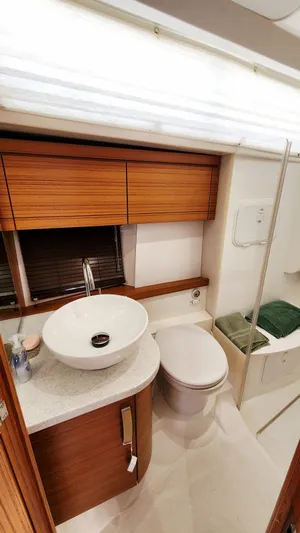 Sea-solar Sue & Lectric Lee Yacht Photos Pics Luxurious bathroom in 2022 Greenline 40 yacht with modern fixtures and wooden cabinetry.