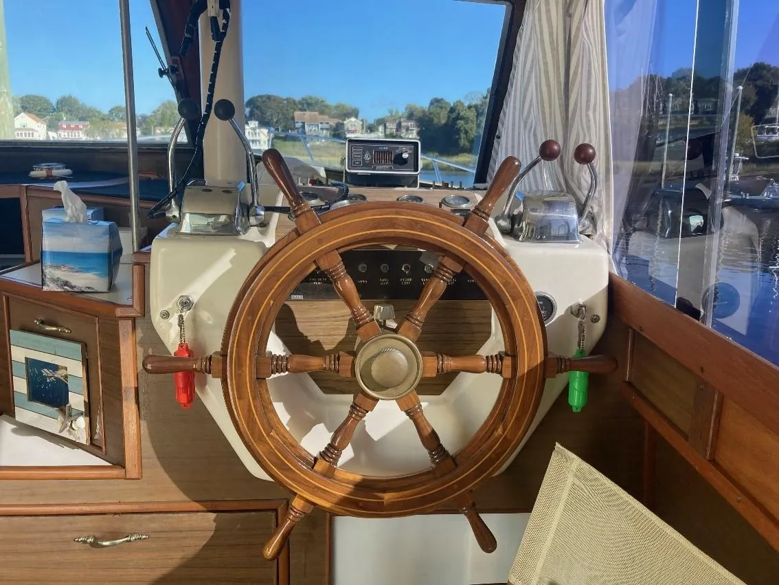 1969 Pacemaker 33 boat helm with wooden steering wheel and control panel.